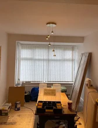 Cluster pendant light fitted over a dining room bay window